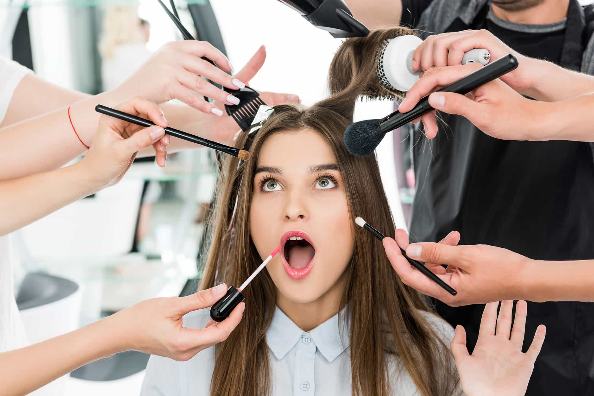 Several makeup artists working on one client at the same time