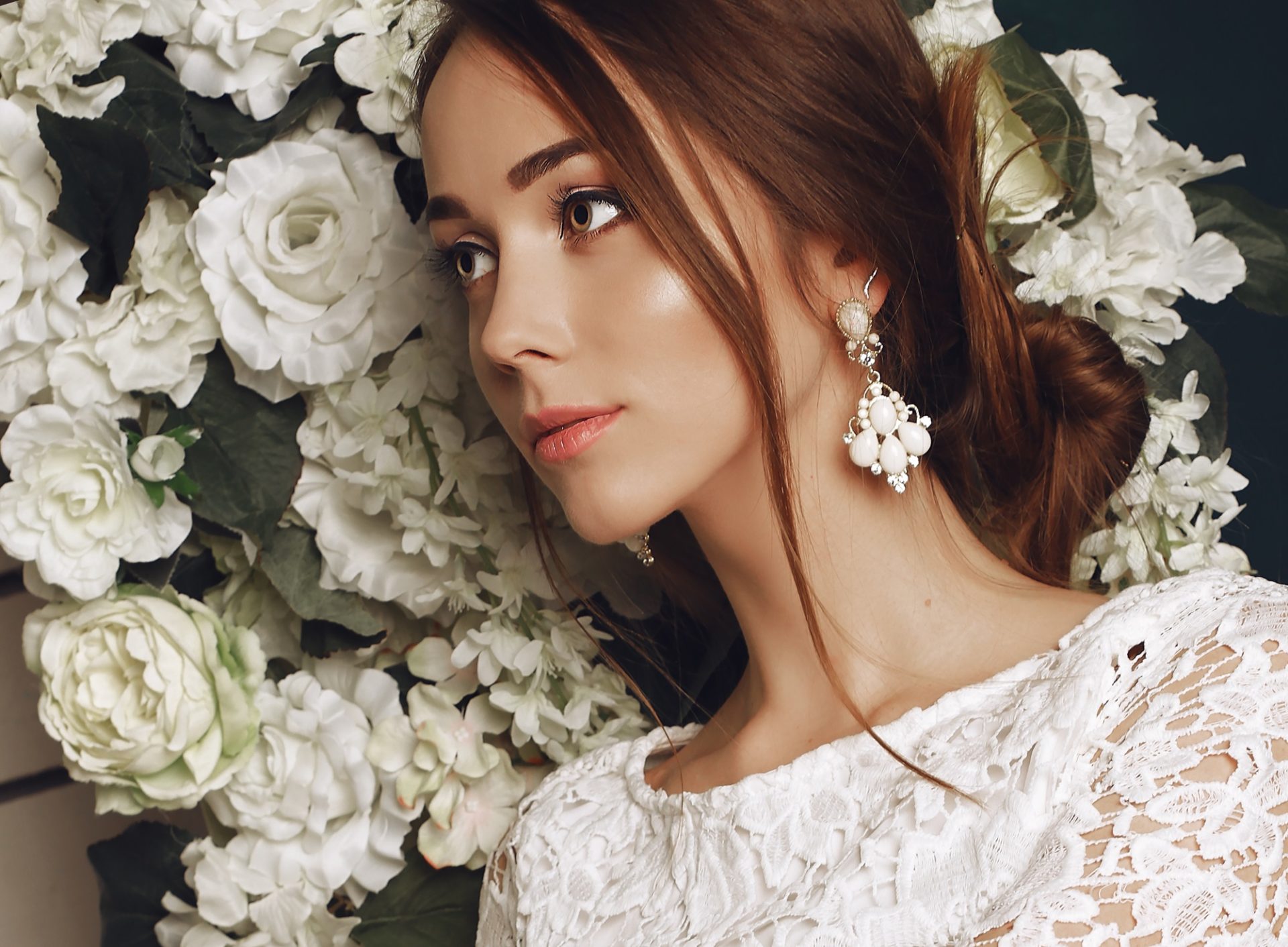 Bride holding flowers after her makeup is finished