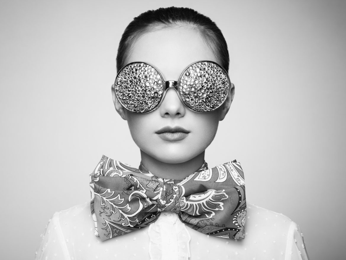 Portrait of beautiful young woman with colored glasses