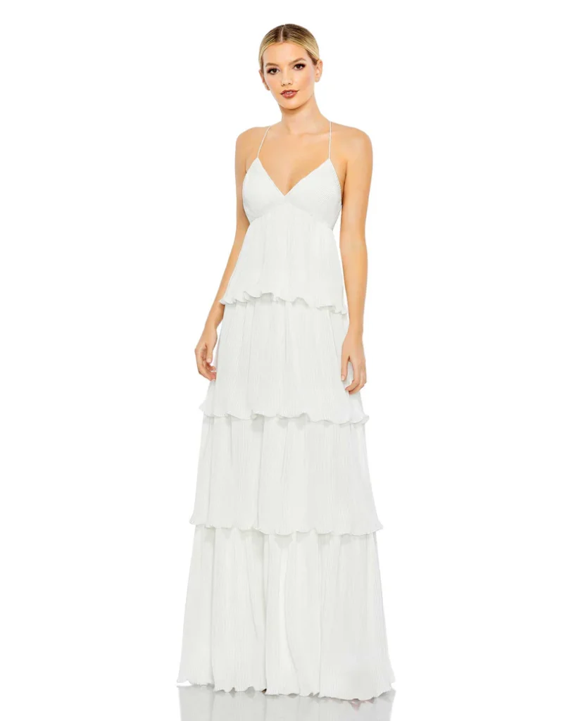 A flowing empire waist gown with delicate spaghetti straps and cascading ruffle layers, offering effortless elegance.