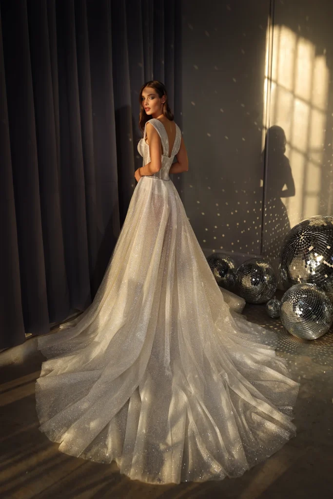 A luxurious, shimmering ball gown with intricate embellishments and a voluminous skirt, perfect for a fairy-tale wedding.