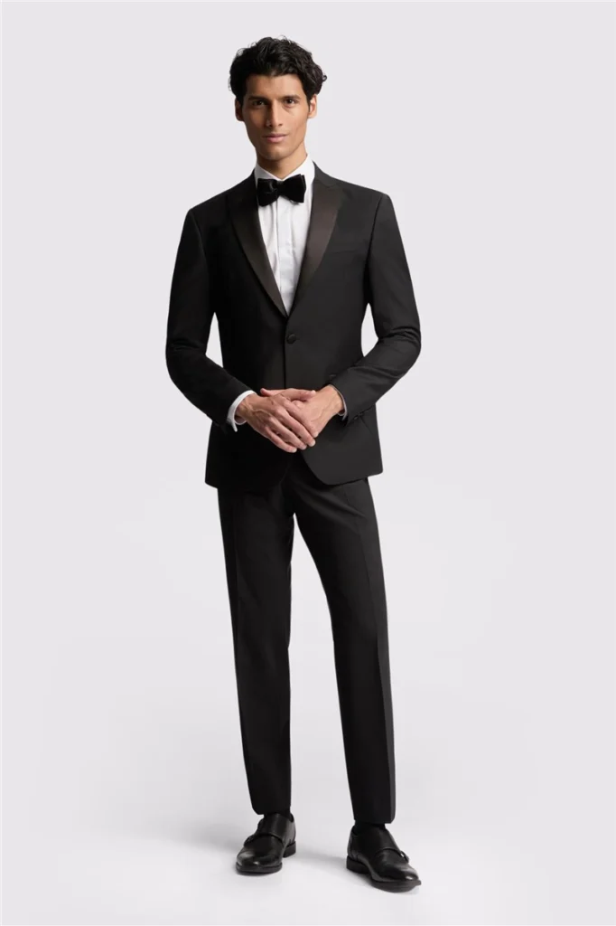 A classic, tailored black tuxedo featuring a sleek slim fit, perfect for a timeless and sophisticated wedding look.
