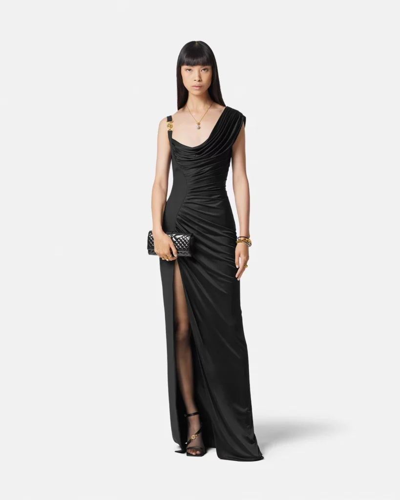 Bold Medusa '95 Draped Gown, combining classic draping with modern flair, representing a powerful evolution of the Little Black Dress through the decades.