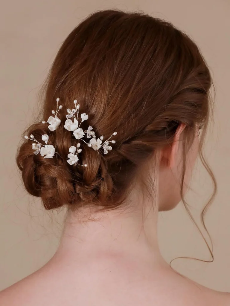 A set of handmade bridal wedding hair pins featuring intricate designs with pearls and delicate crystals, adding a touch of elegance and sparkle to the bride's hairstyle.