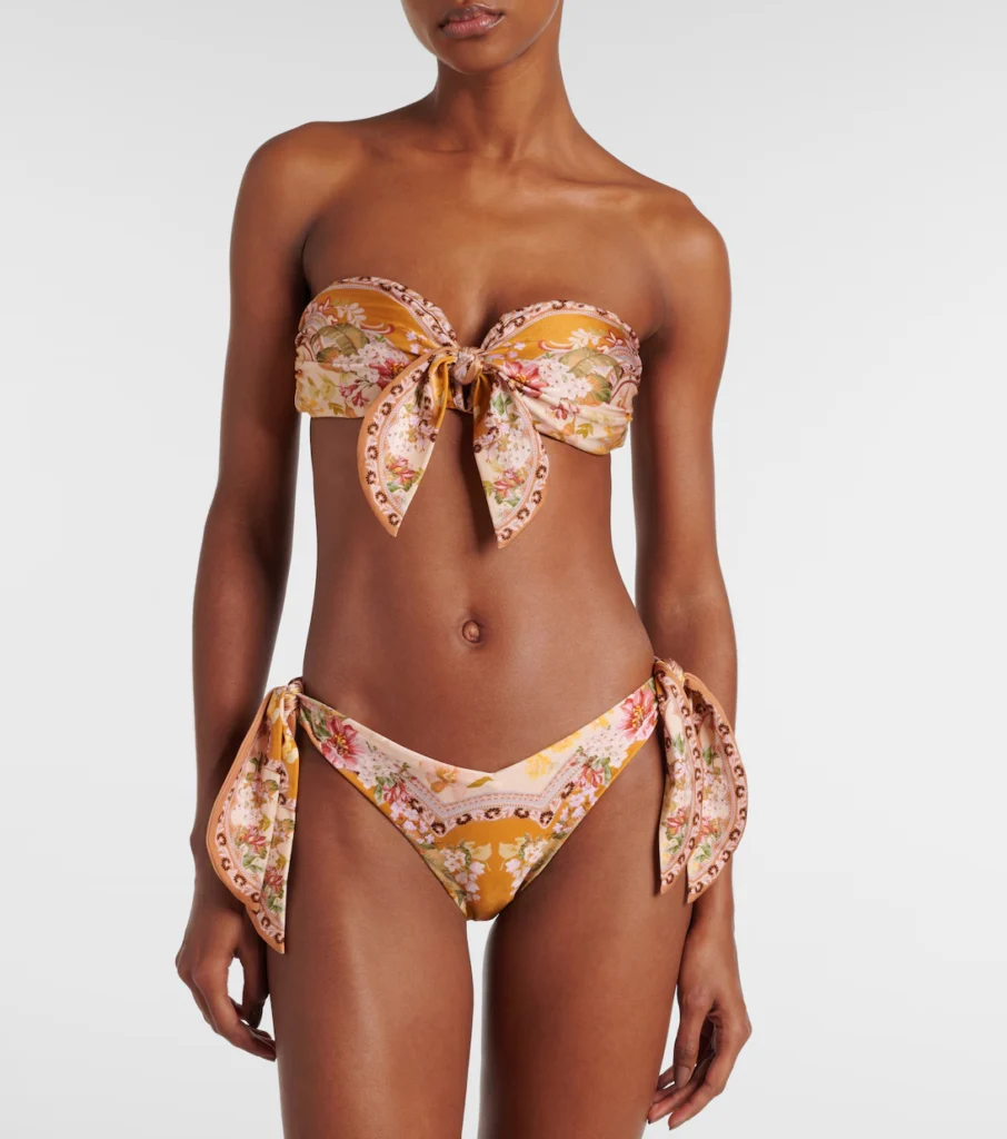 The Wylie Scarf Tie floral bikini showcases a colorful floral pattern with chic scarf ties, providing a flattering fit and a stylish, feminine vibe for beach days.