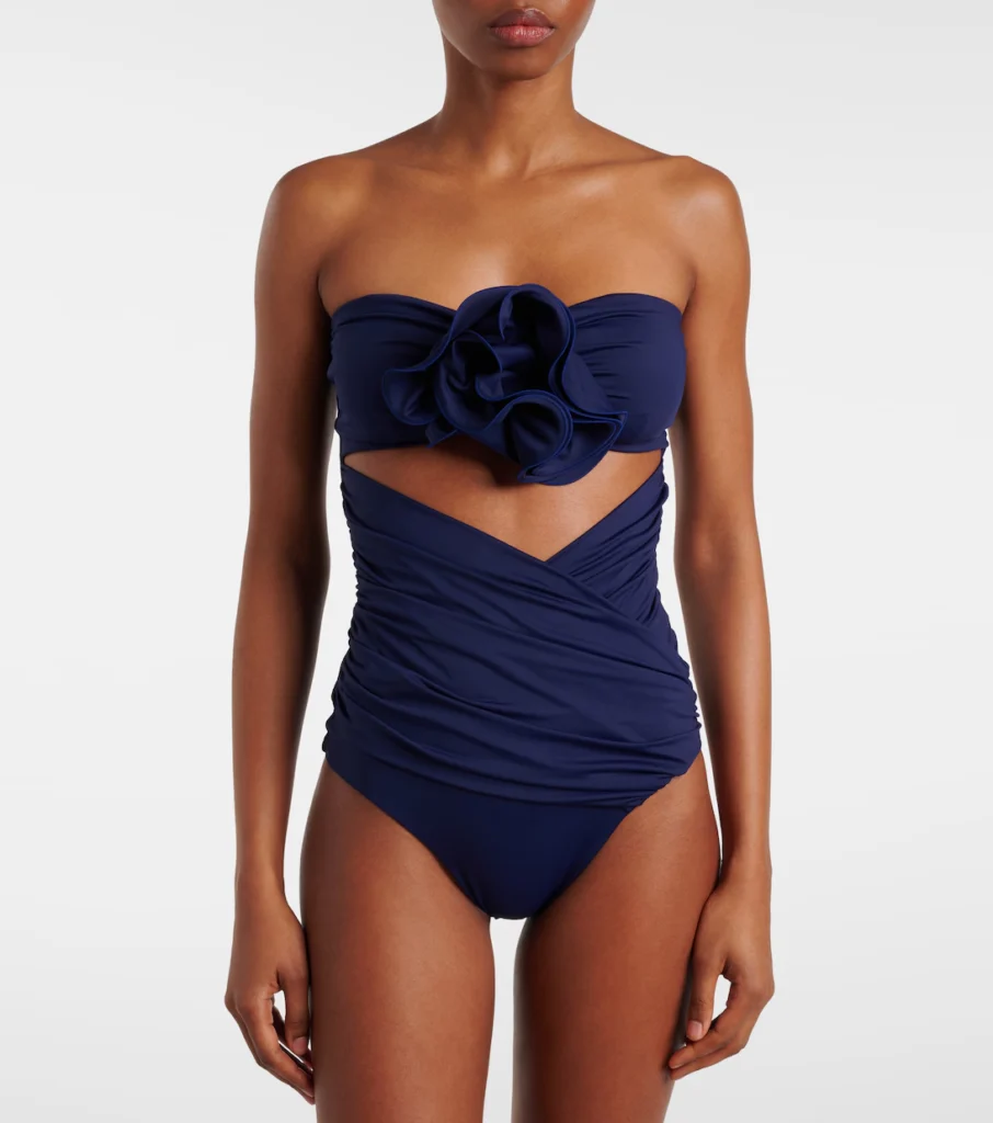 The RE25 swimsuit offers a stylish and functional design, providing a flattering fit with modern details for both relaxation and swimming.