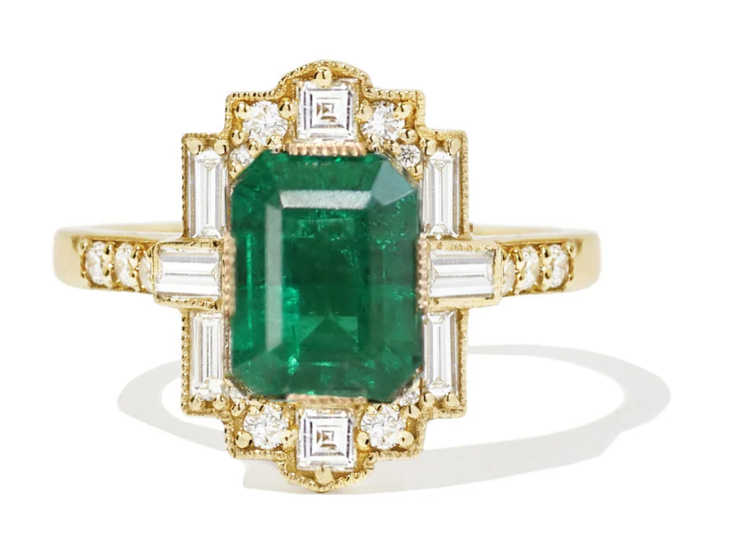 Classic Deco lines frame a striking emerald-cut centerpiece.