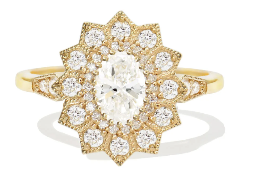 A burst of brilliance blooms around a classic oval diamond.