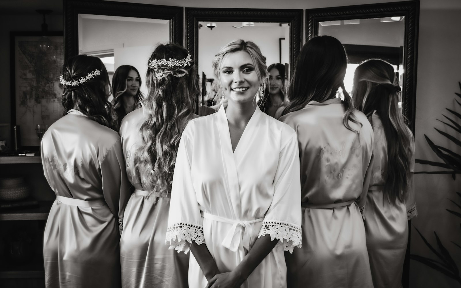 Bride and bridesmaids in robes in the getting-ready room