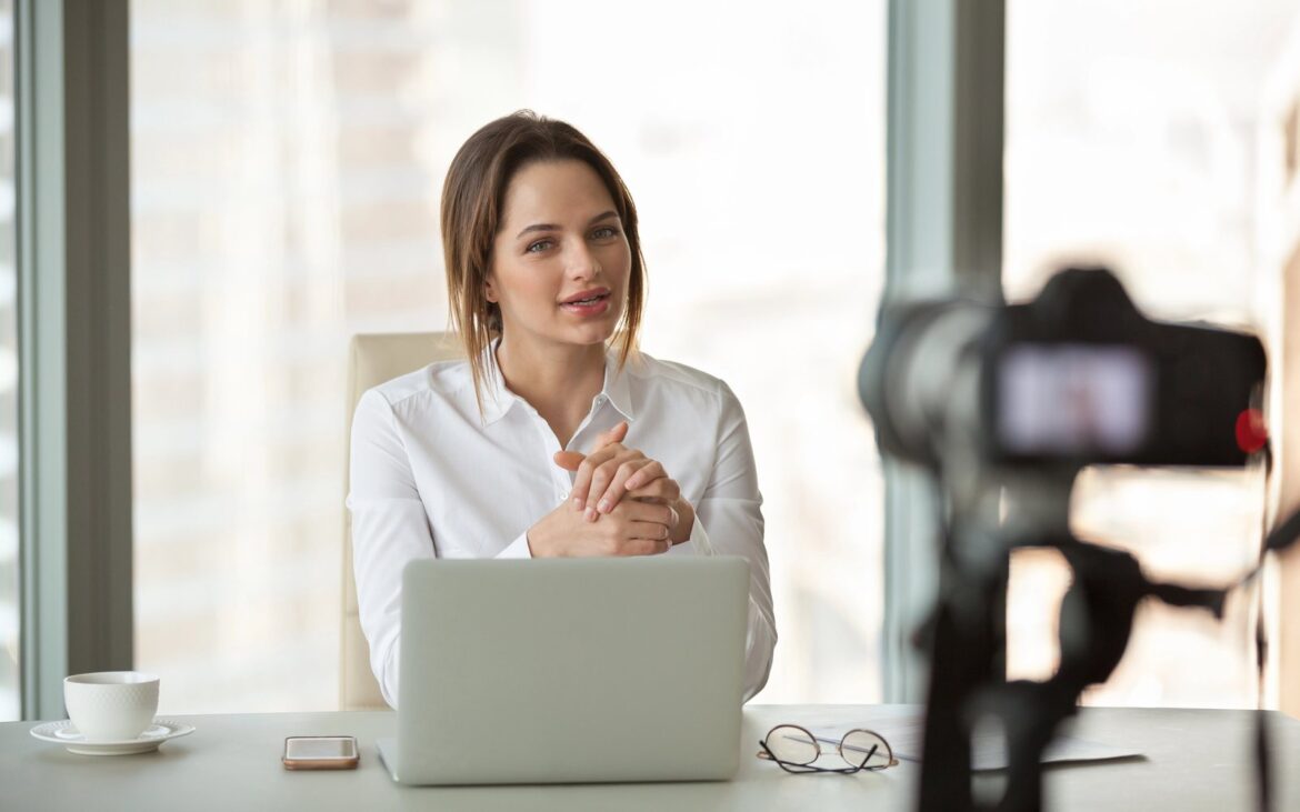 Businesswoman talking to a camera at her desk during a video call