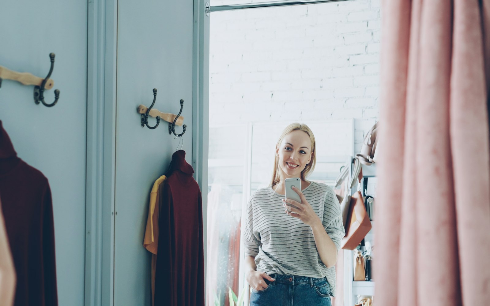 Woman taking a mirror selfie in a dressing room