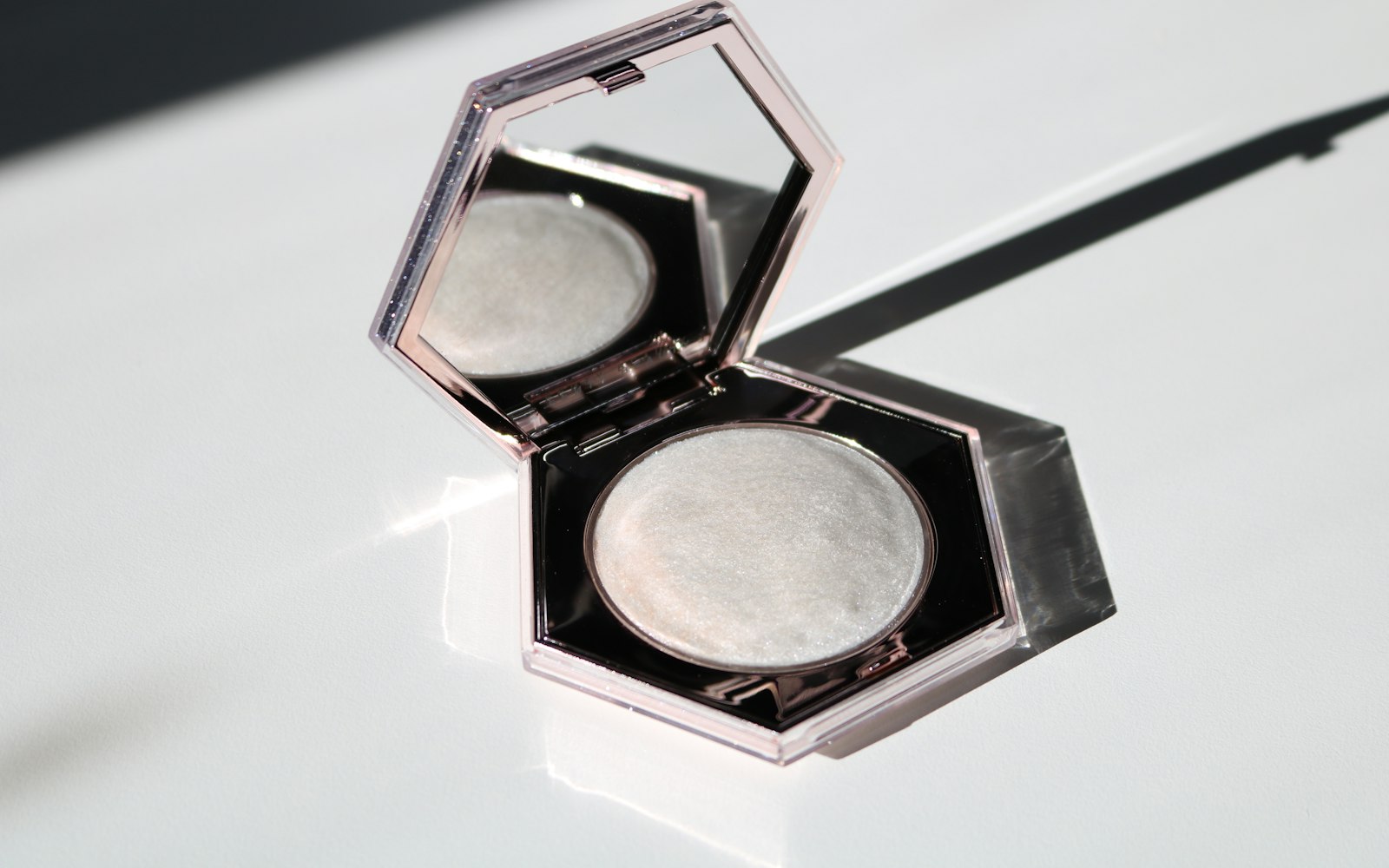 Open hexagonal highlighter compact on white