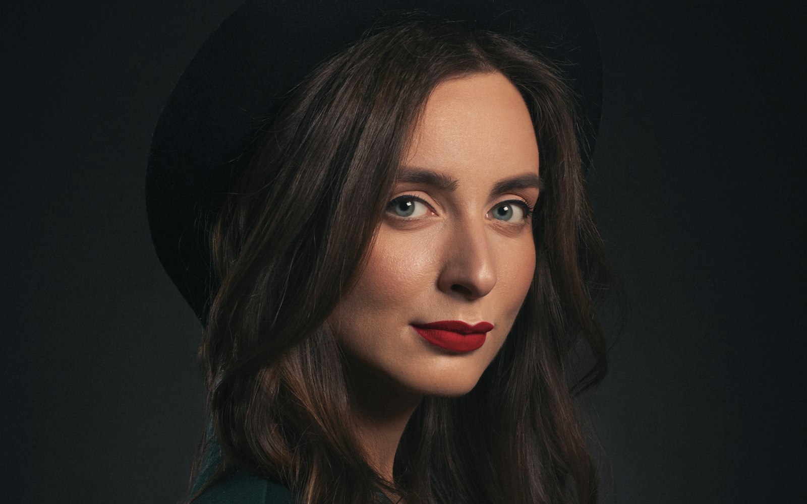 Front-facing portrait with defined brows and a red lip