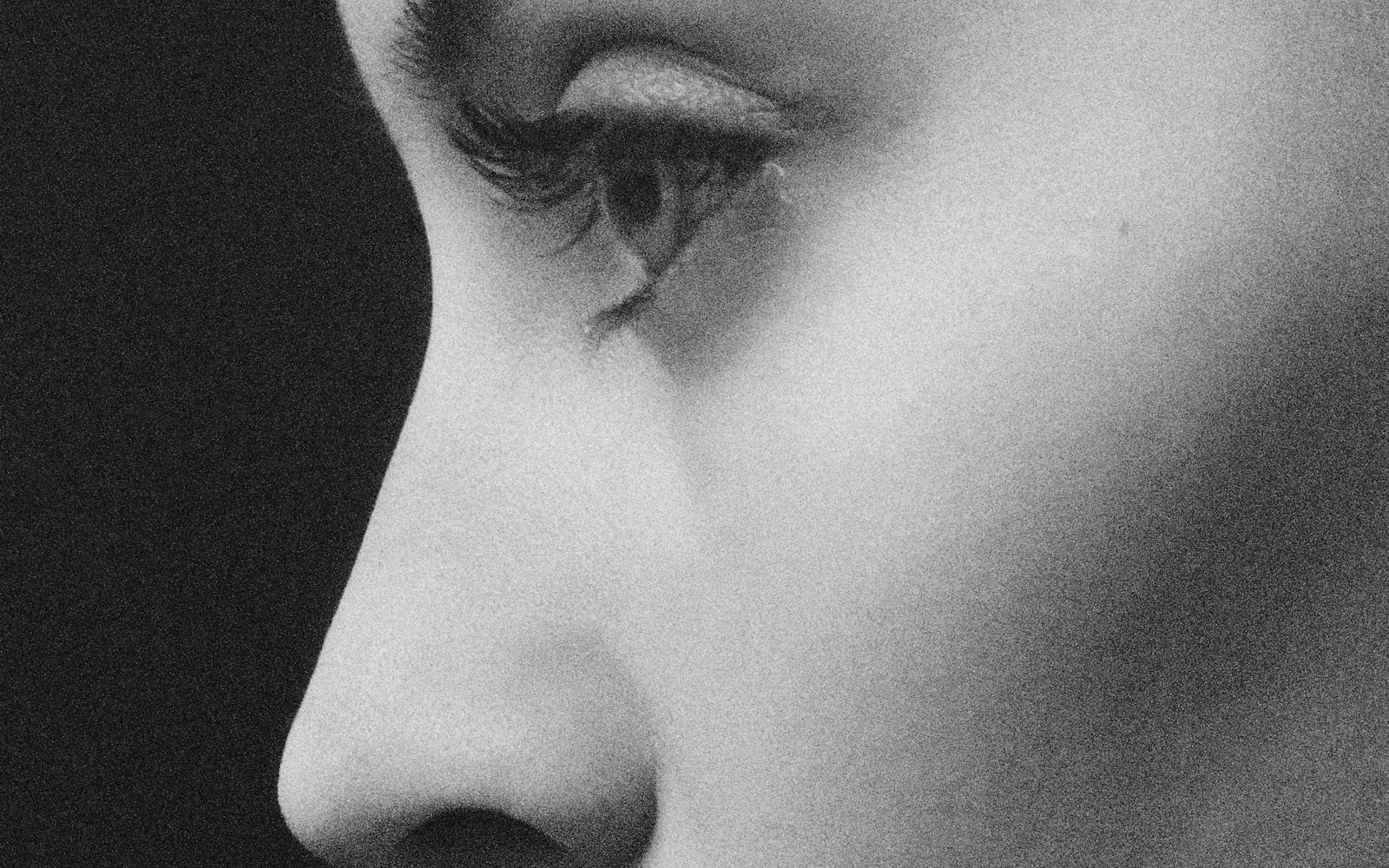 Black-and-white close-up of a profile showing brow, nose and lips