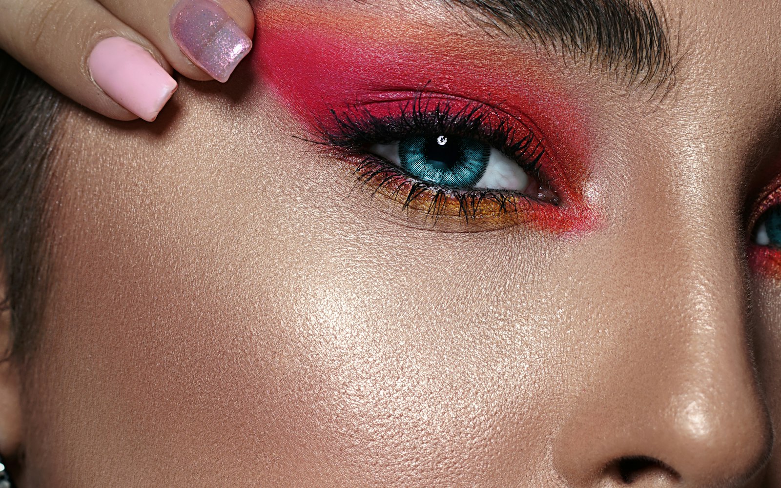 Close-up of pink and coral eyeshadow on glowing skin