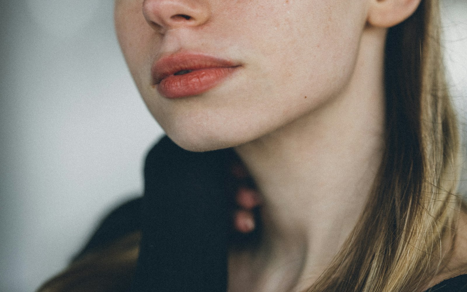Soft coral lip and natural skin in close-up