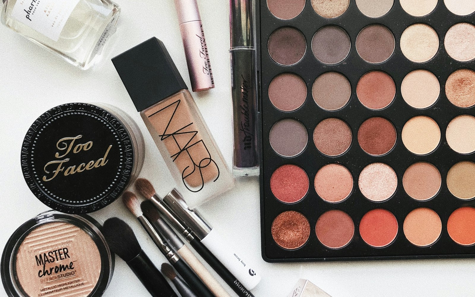 Close-up of lipsticks, powders and brushes