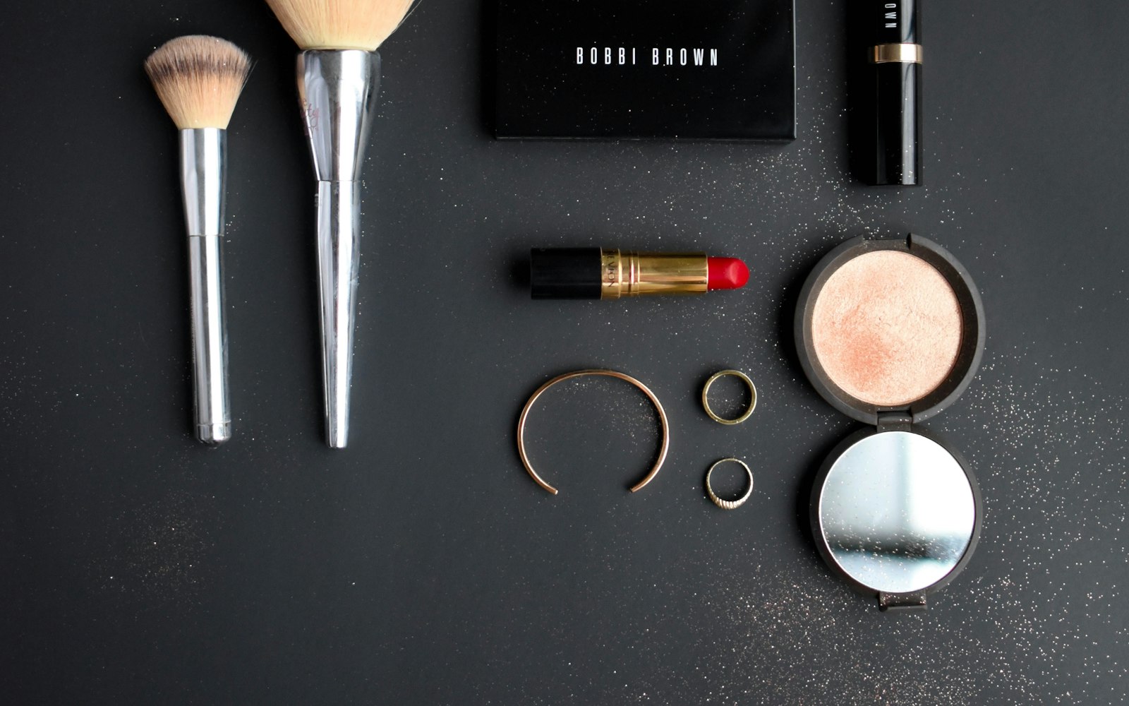 Assorted makeup products laid out on a table