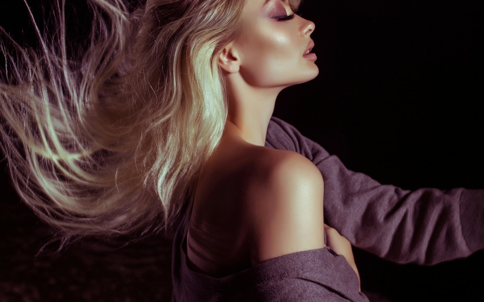Editorial portrait of a woman with flowing hair in warm light