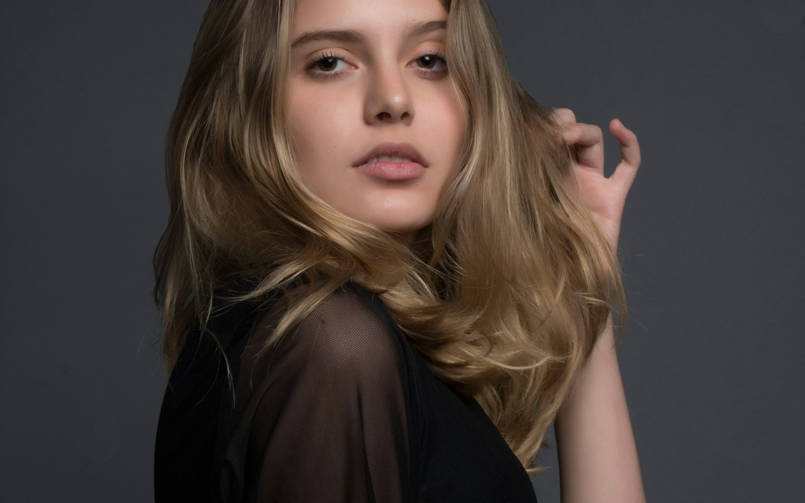 Editorial portrait of a woman with soft natural makeup