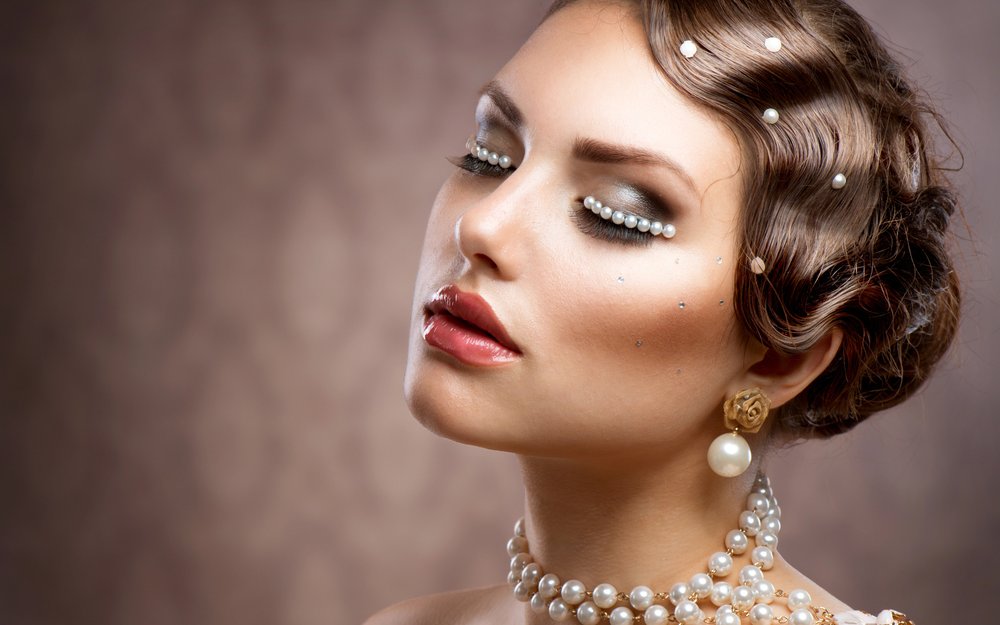 Editorial makeup with pearls placed along the lash line and in the hair