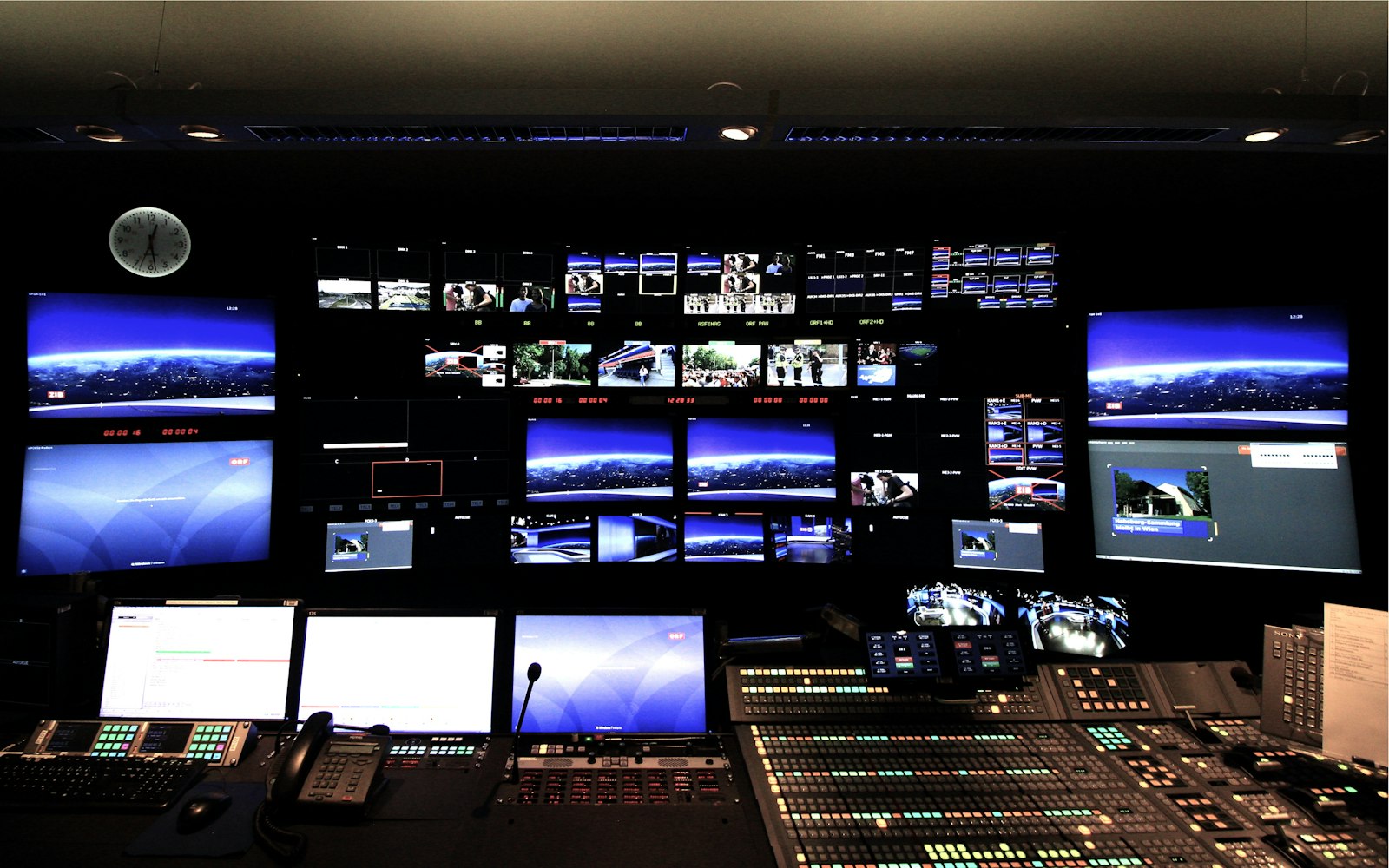 Broadcast control room with rows of monitors