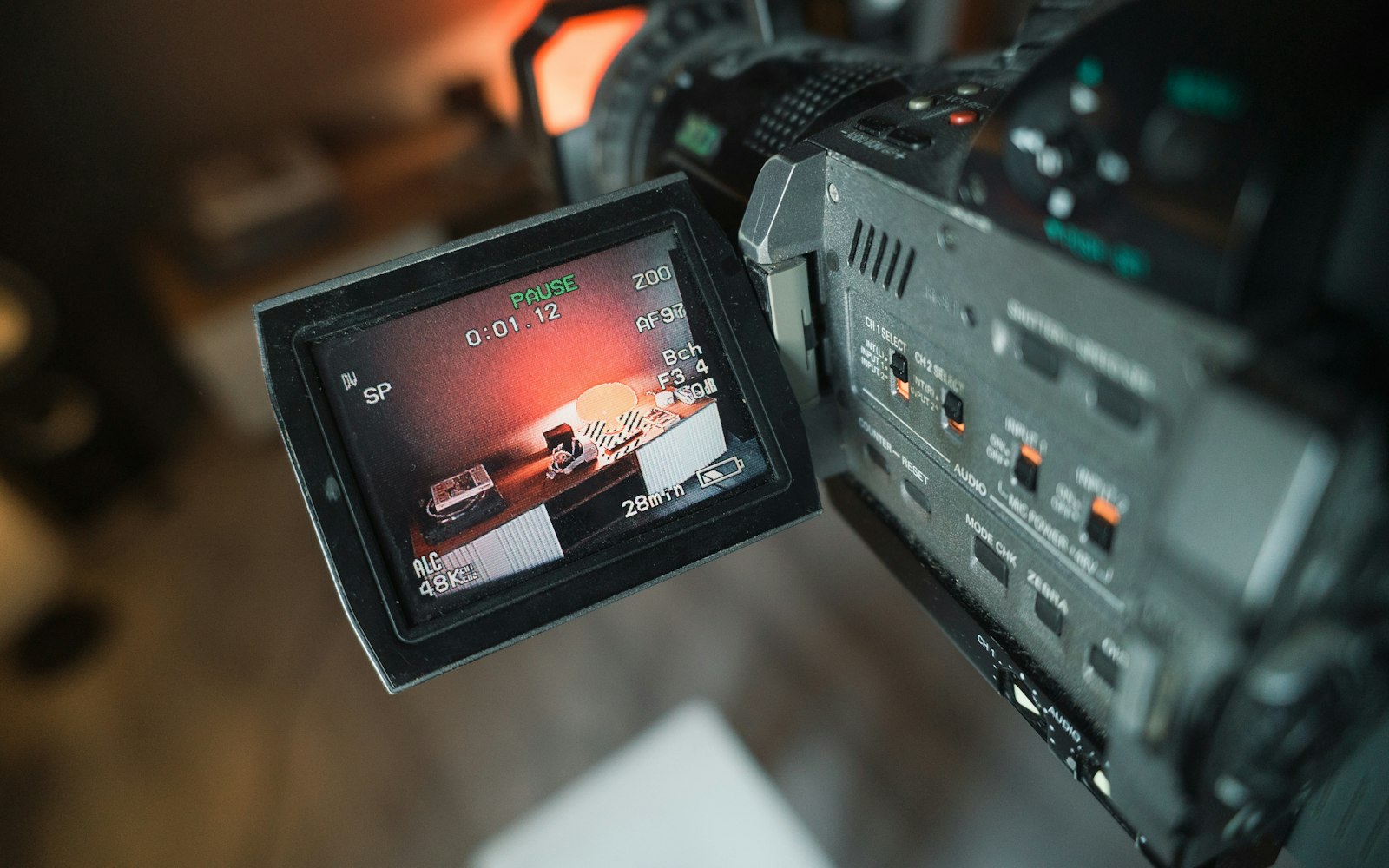 Video camera with its flip-out monitor showing the frame