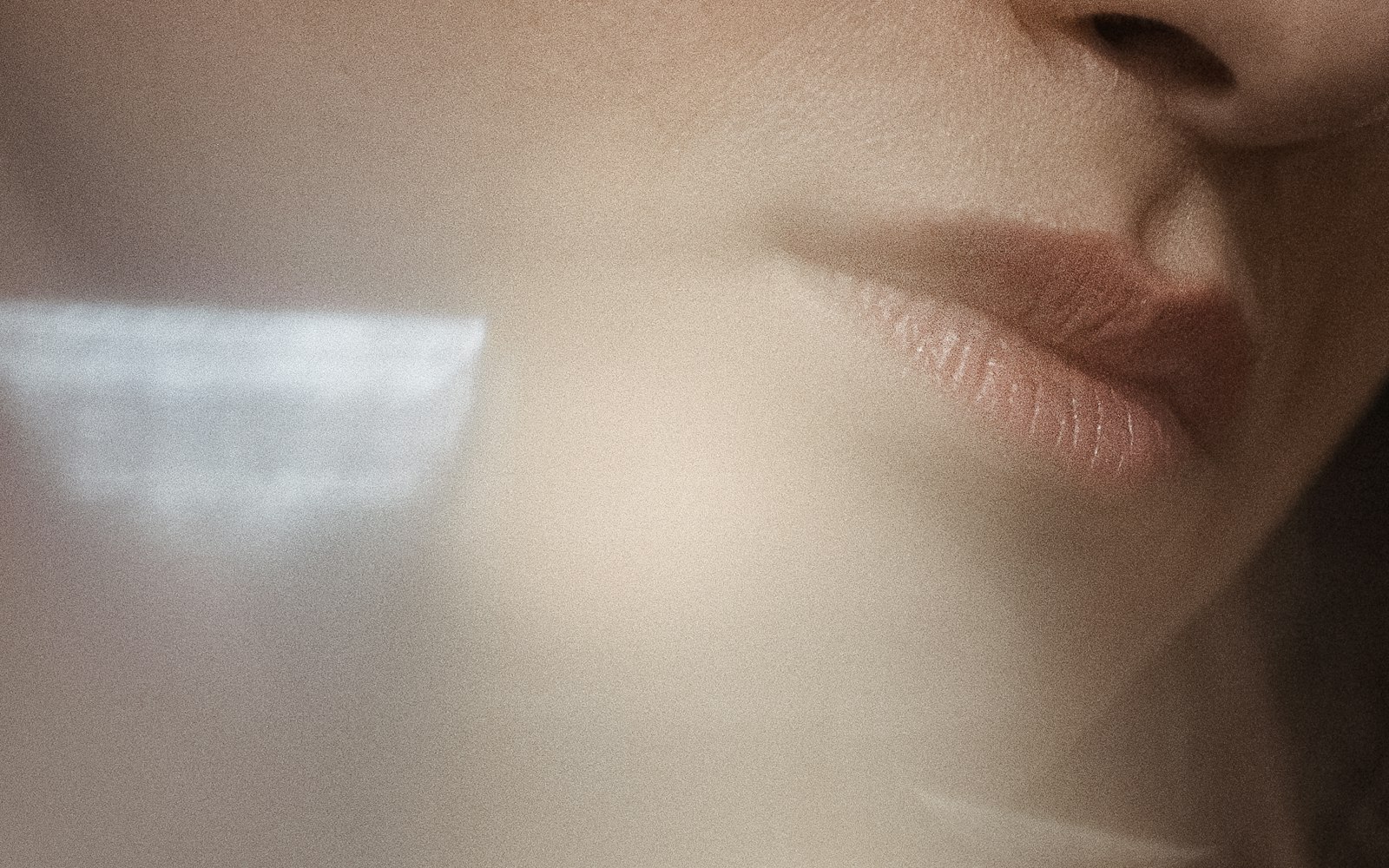 Soft close-up of skin and lips in diffused light