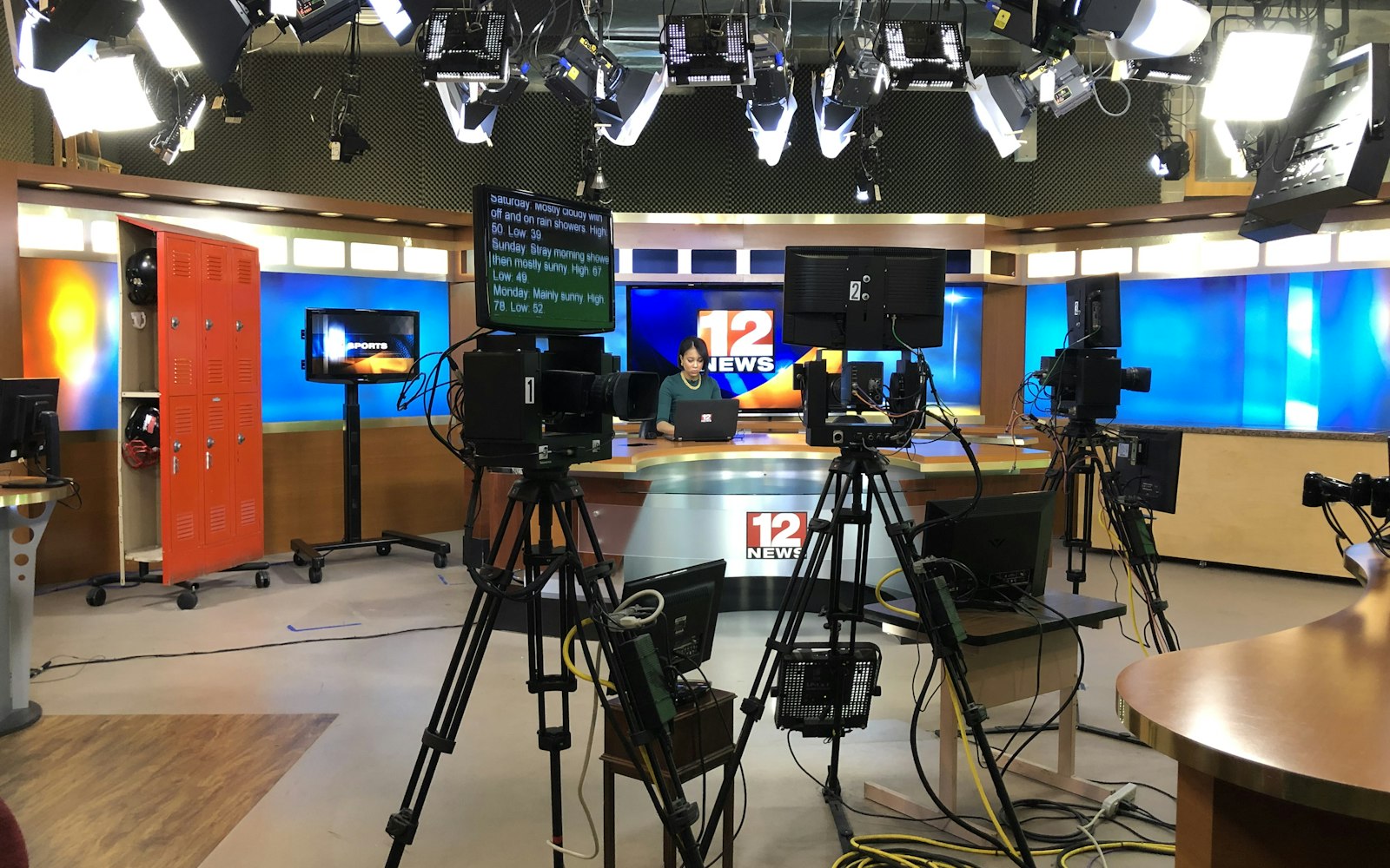 Television news set with cameras and studio lights