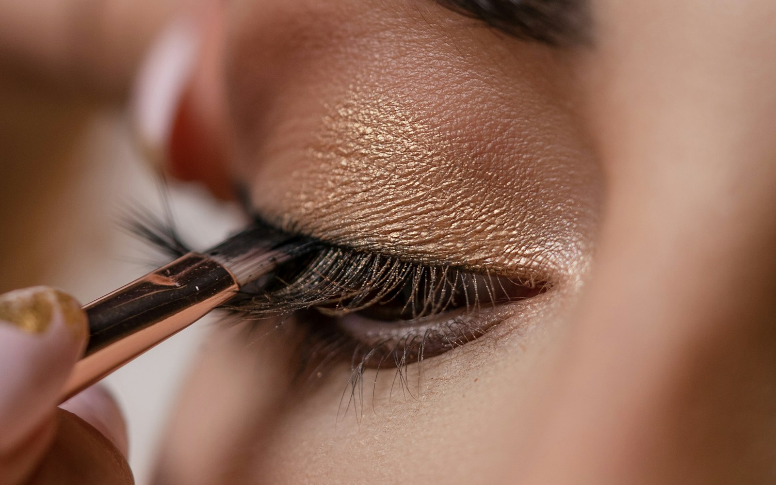 Makeup artist applying eyeshadow to a client with a brush