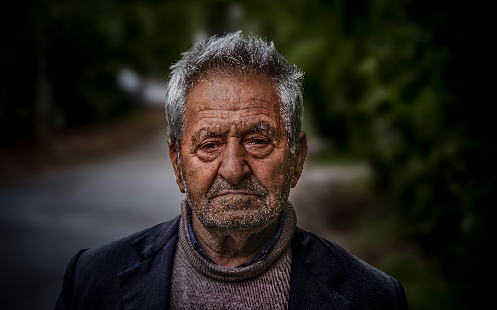 Portrait of an older man with deep lines and gray hair