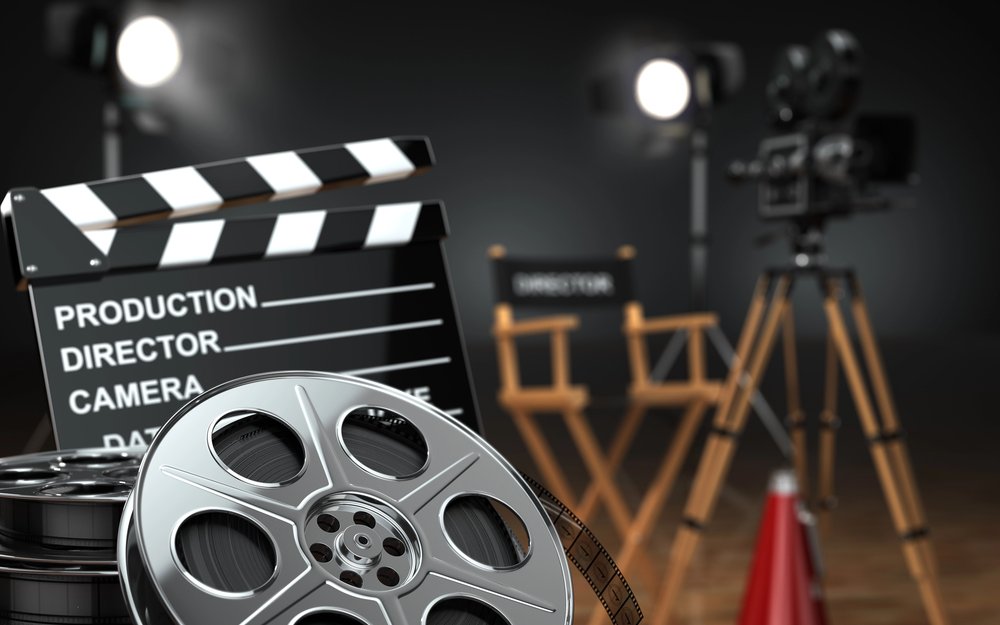 Retro film camera, reels and a clapperboard on set