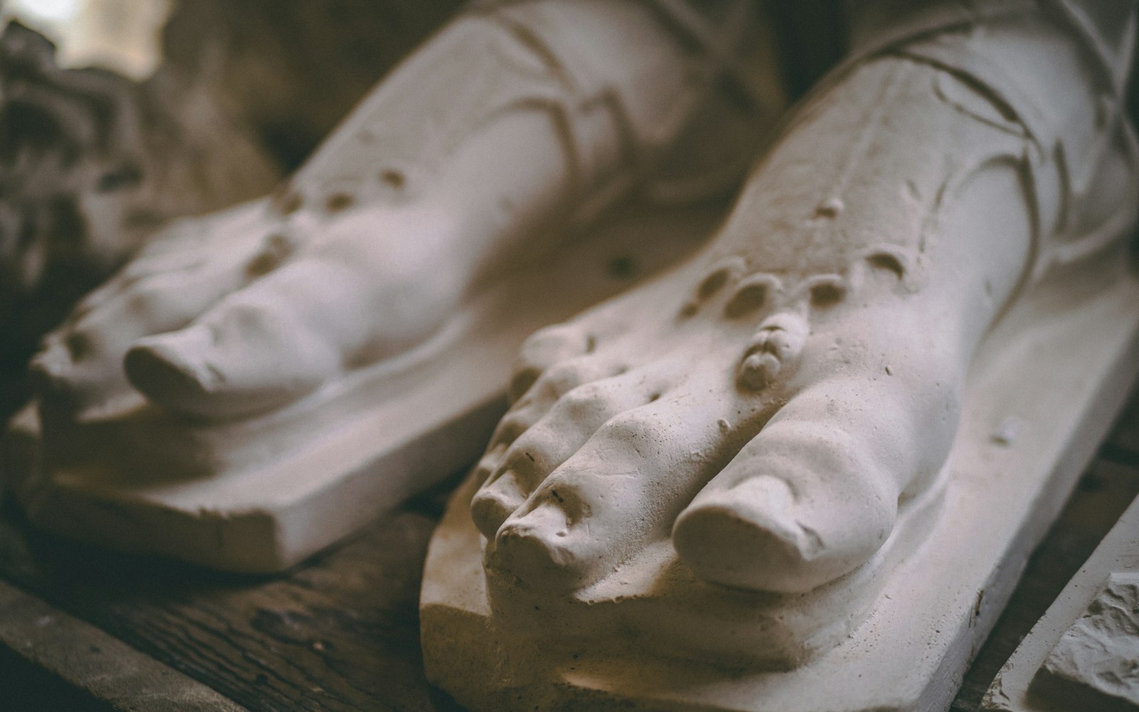 Plaster casts of feet on a workshop table