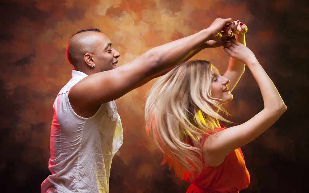 Two dancers performing a lifted spin on stage